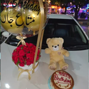 Red roses box arrangement with a teddy bear, custom birthday cake, and personalized Urdu/English balloon