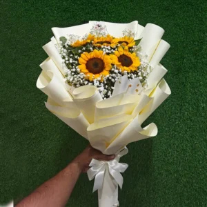 Sunflowers with Gypsophila fillers in a grand cream/white paper bouquet presentation
